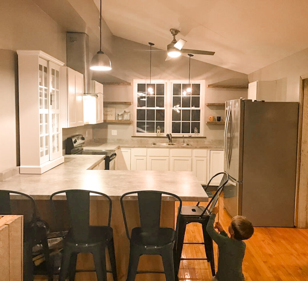 newly renovated kitchen with child playing under counter