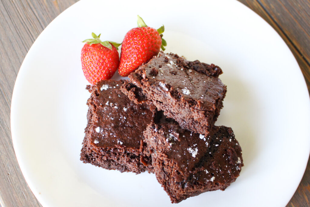 sourdough brownies served on plate with strawberries