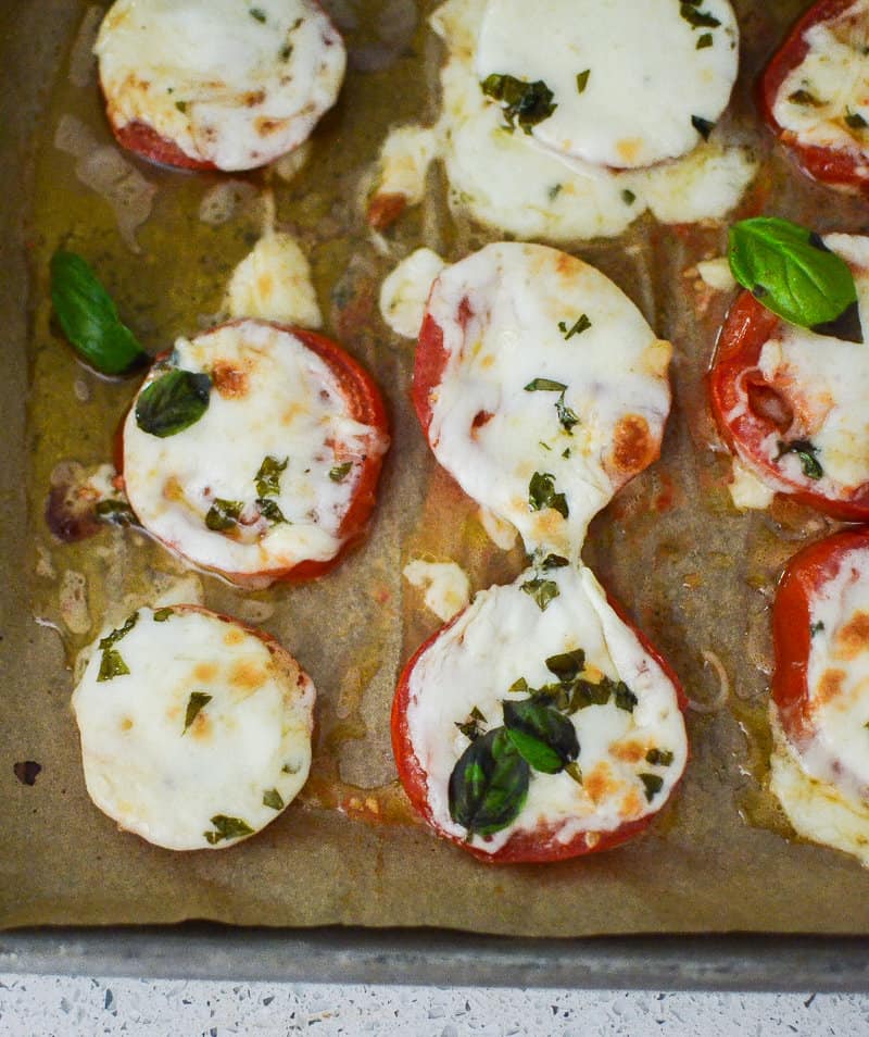 fresh tomatoes topped with melted mozzarella and basil