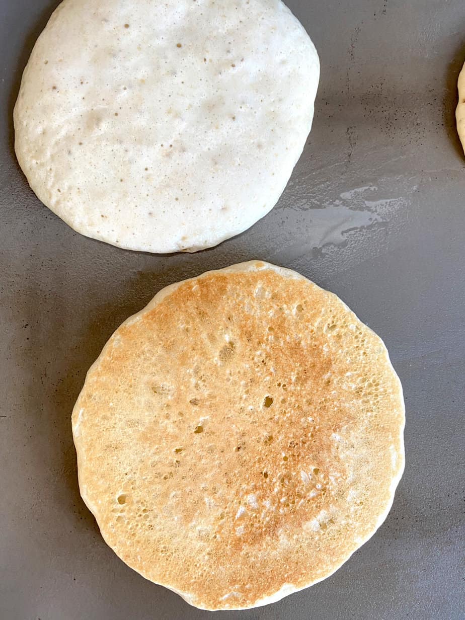 sourdough pancakes cooking on griddle