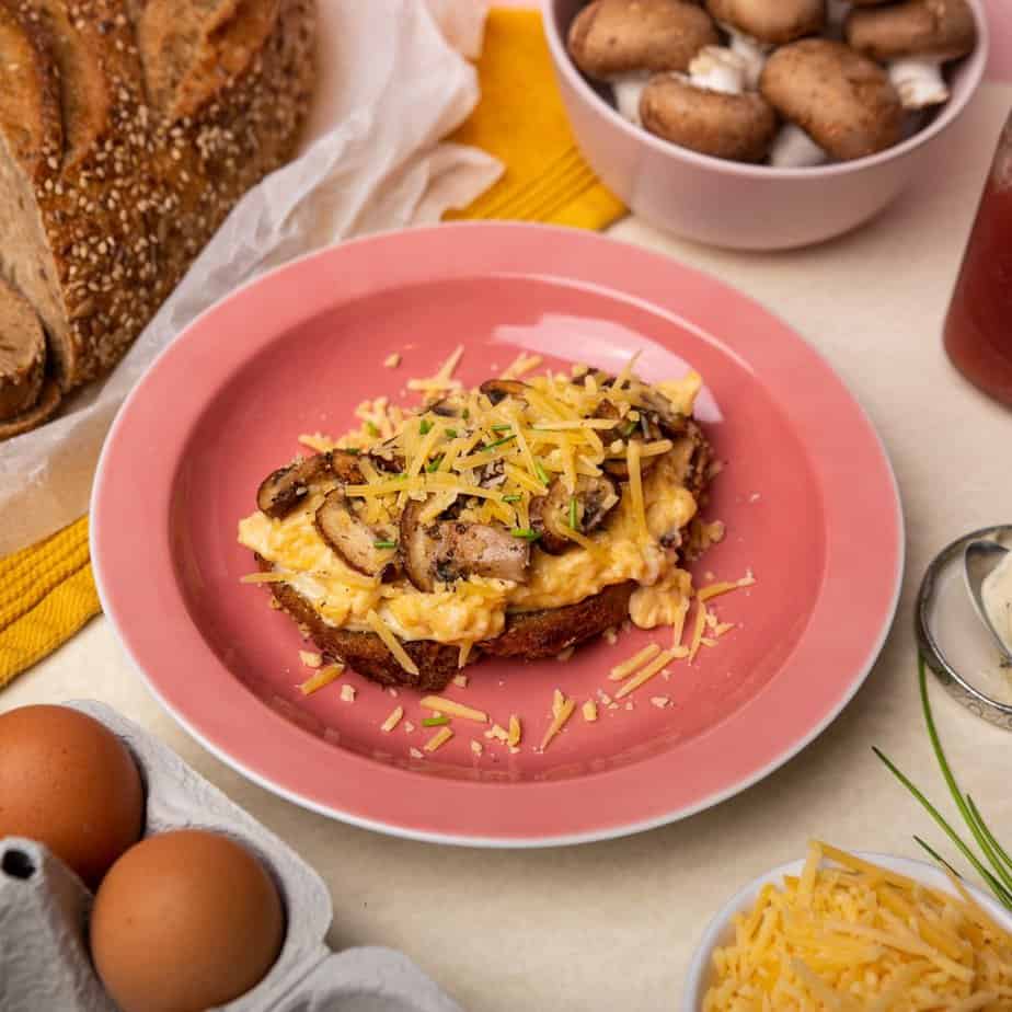sourdough toast topped with eggs mushrooms and cheese