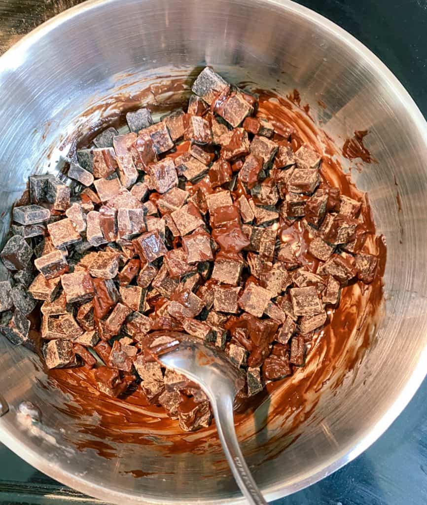 dark chocolate chunks melting in saucepan
