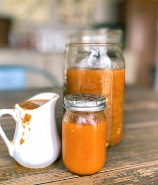 homemade fermented and unfermented hot sauces in jars and pitcher