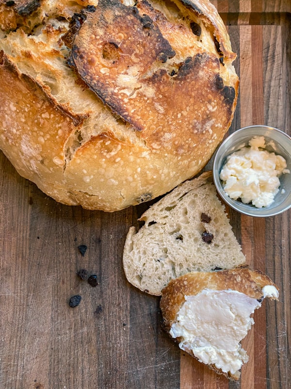 chocolate chip sourdough bread served with honey cream cheese on hess woodworks cutting board