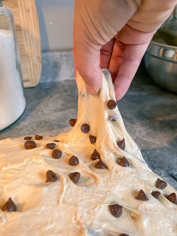 stretching bread dough with chocolate chips