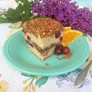 cranberry coffee cake with crumb topping on plate