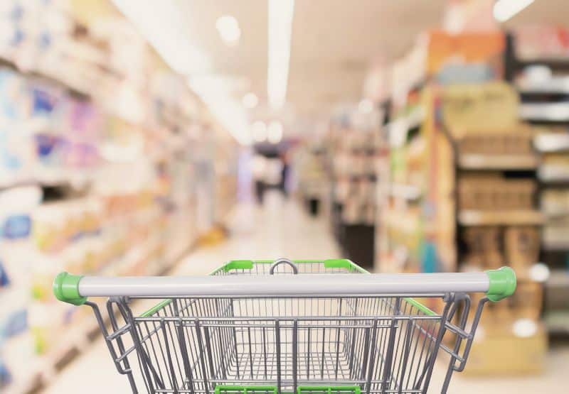 shopping cart going through grocery aisle