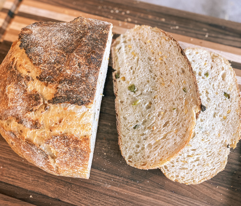 jalapeño cheddar sourdough bread sliced on wooden board