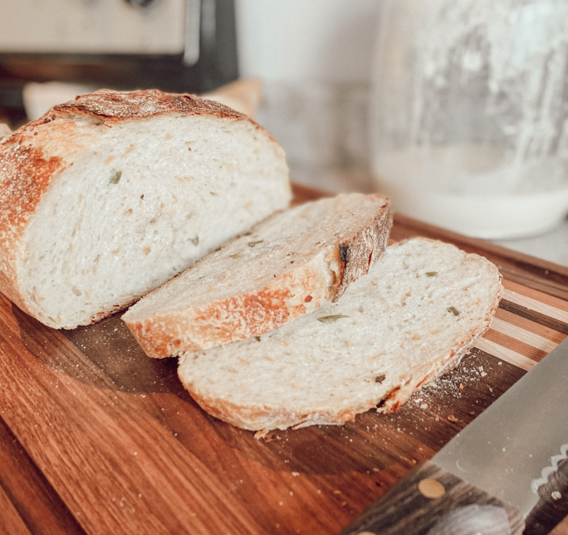 slices of jalapeño cheddar bread on wooden carving board