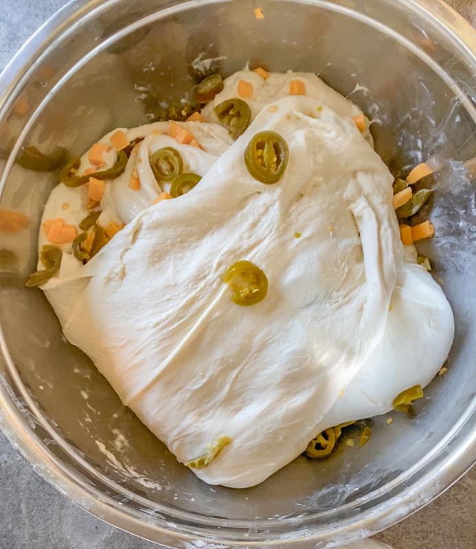 sourdough bread dough with pickled jalapeños and diced cheddar