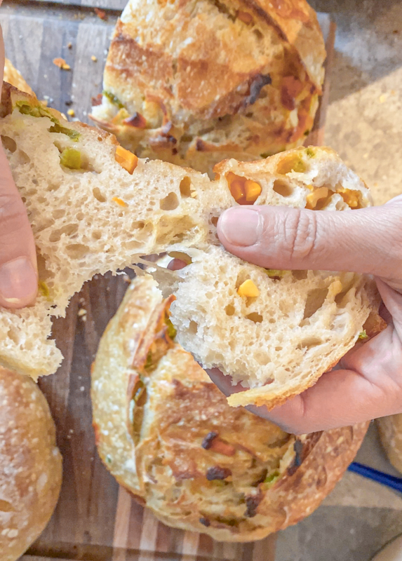 sourdough bread with jalapenos and cheese being pulled apart